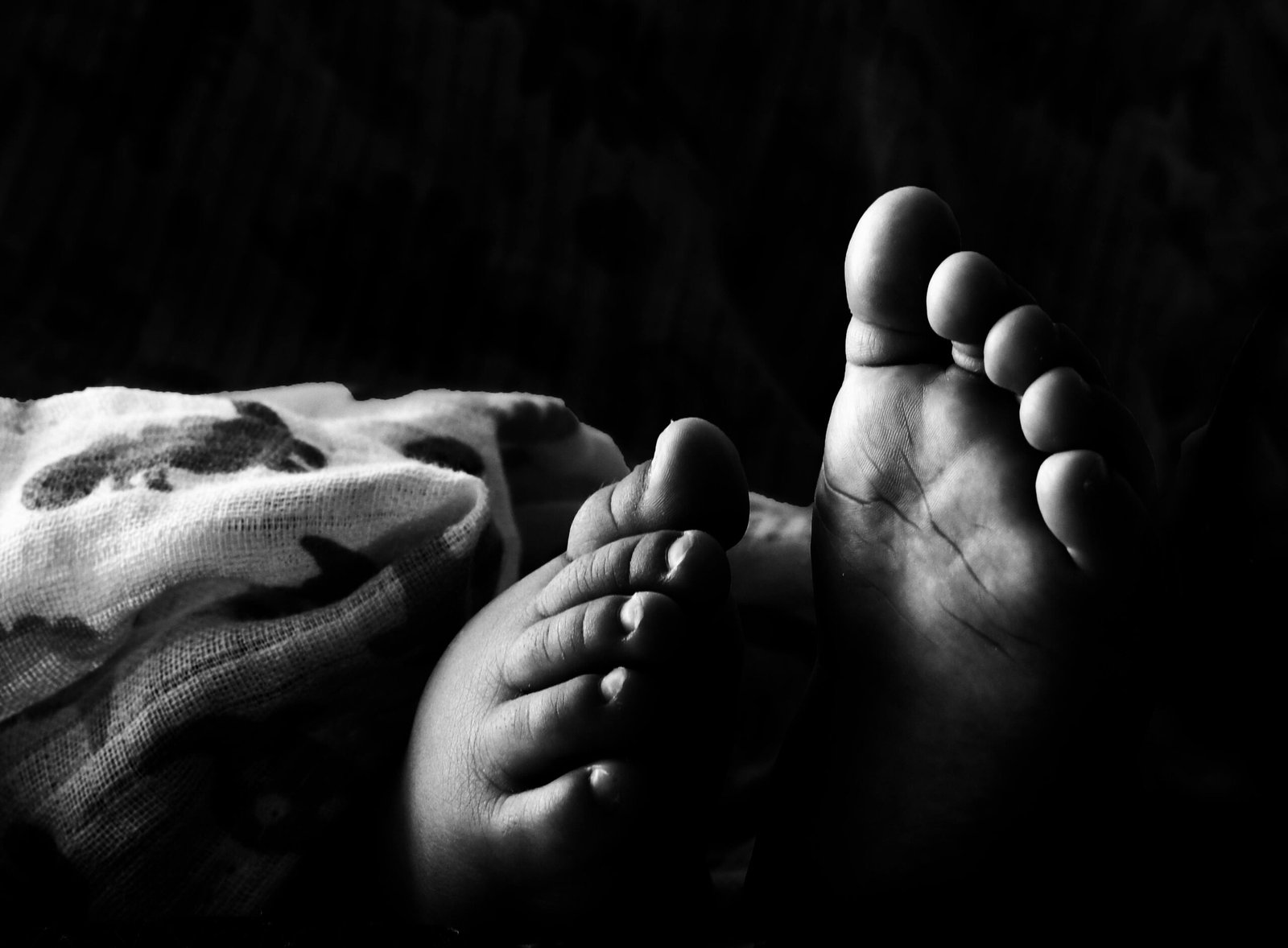 Captivating black and white photo of an infant's feet, symbolizing innocence and new beginnings.